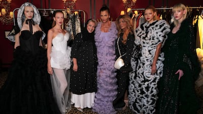 Model Helena Christensen, centre, flanked by Atelier Hekayat designers Alia and Abeer Oraif at their fashion show in London. Photo: AlUla Creates / British Fashion Council