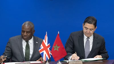British Foreign Secretary David Lammy, left, and Moroccan Foreign Minister Nasser Bourita sign agreements after a meeting in Rabat. EPA