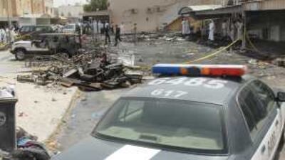 Emergency workers sift through the debris left by the deadly wedding tent fire in Jahra, Kuwait.