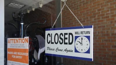 A closed sign hangs in the window of a barber shop in Burbank, California. Millions of jobs lost during the pandemic are unlikely to come back. AP