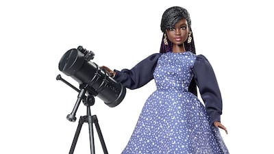 Dr Maggie Aderin-Pocock MBE doll features a rendition of the space scientist wearing a starry dress and has a telescope accessory - a nod to Dr Aderin-Pocock's work with the James Webb Space Telescope.