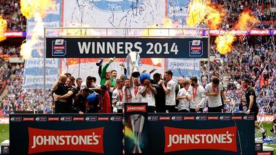 Peterborough players celebrate with the trophy after winning the Johnstone's Paint Trophy Final between Chesterfield and Peterborough United at Wembley Stadium on Sunday. Ben Hoskins / Getty Images / March 30, 2014