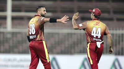 Sayed Shirzad, left, of the Kandahar Knights celebrates the wicket of Johnson Charles of the Nangarhar Leopards.