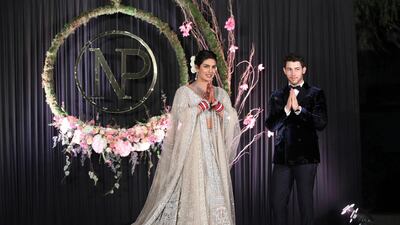 Newlyweds Priyanka Chopra, 36, and Nick Jonas, 26, pose for a photograph during a reception at a hotel in New Delhi on December 4, 2018. Photo: EPA