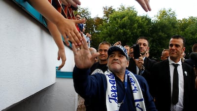 Diego Maradona is greeted by Dynamo Brest fans. Reuters