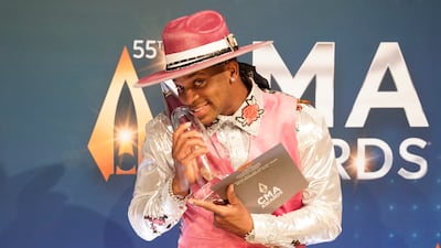 Jimmie Allen poses in the press room with the New Artist of the Year award. AP