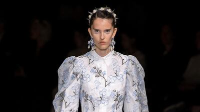 A sheer embroidered dress is worn over a white shirt dress at Simone Rocha spring summer 2020