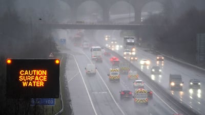 Vehicles make their way through heavy rain on the M80 near Banknock, in Scotland. PA