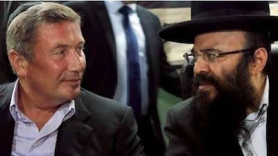 Rabbi Yaakov Israel Ifargan, right, known as the 'X-Ray' for the belief he has the ability to diagnose patients by eyesight only, sits with businessman Nochi Dankner at the annual gathering of his supporters.