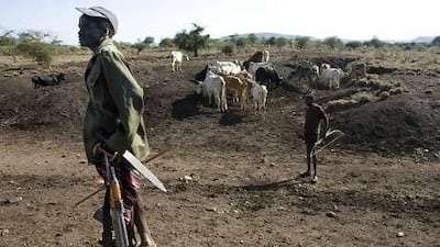 Armed with an AK-47 and a long knife, a Pokot herder guards his cattle in Northern Kenya, where ribal tribes are fighting over grazing land.
