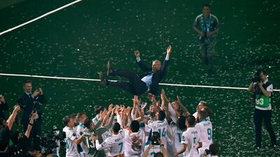 Real Madrid's players toss coach Zinedine Zidane while Real Madrid celebrate their Champions League Final win at Santiago Bernabeu, Madrid, Spain. May 27, 2018. Gabriel Bouys / AFP