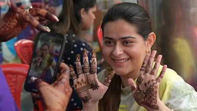 A woman has her hands decorated with henna on the eve of the Hindu festival of Karva Chauth in Amritsar. India’s festive season usually runs for several weeks. AFP