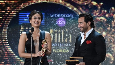 Bollywood actress Kareena Kapoor and Bollywood actor Saif Ali Khan present the award for Best Playback Male Singer at the 2014 International Indian Film Academy (IIFA) Awards. AFP