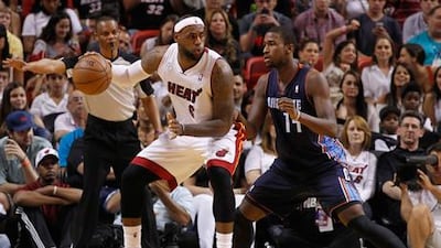 Charlotte Bobcats' Michael Kidd-Gilchrist guards LeBron James at the American Airlines Arena.