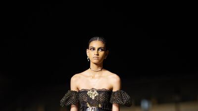 A sheer black and gold dress, as part of the Dior Cruise 2023 show in Seville. Getty Images