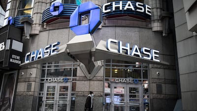 A pedestrian wearing a protective mask walks past a JPMorgan Chase & Co. bank branch in New York, U.S., on Friday, April 10, 2020. JPMorgan Chase is scheduled to release earnings figures on April 14. Photographer: Mark Kauzlarich/Bloomberg