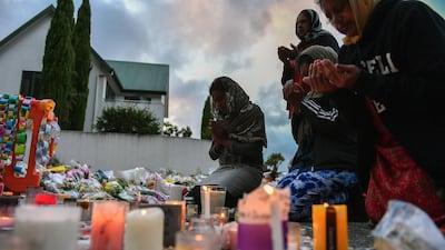 Worshippers pray at a makeshift memorial at the Al Noor mosque in Christchurch, after a terrorist attack in which 50 people were killed. EPA
