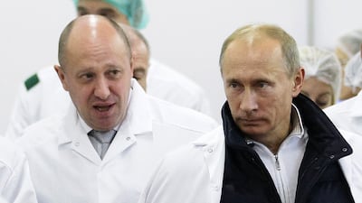 Head of the Wagner Group Yevgeny Prigozhin, left, with Vladimir Putin, in St Petersburg. AP