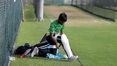 Ryan Paramasivam puts on his pads as cricket training returns at Its Just Cricket academy in Jebel Ali. Chris Whiteoak / The National