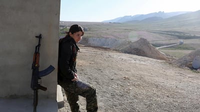 A PKK fighter outside a base in Sinjar. Many of the women have cut links with their families. They come from all corners of the Kurdish region. Asmaa Waguih / Reuters