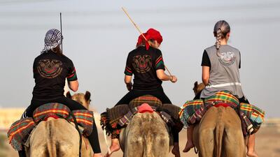 Linda Krockenberger, centre, leads a training session for women at the Arabian Desert Camel Riding Centre near Dubai. EPA