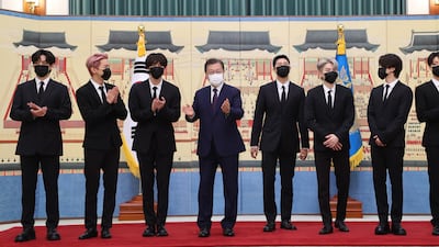 South Korean President Moon Jae-in, fourth from left, with members of BTS during a ceremony to mark the appointment of the K-pop septet as his special envoy for future generations and culture. EPA