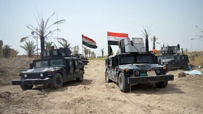 Iraqi security forces vehicles drive through Shuhadaa neighborhood in Fallujah, Iraq. Reuters