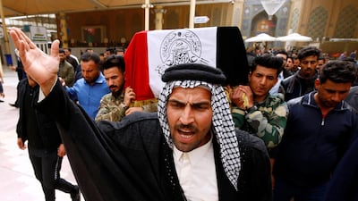Mourners carry coffins of Iraqi Federal police officers who were killed by U.S. airstrike, during a funeral in Najaf, Iraq. REUTERS