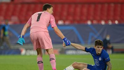FC Porto' goalkeeper Agustin Marchesin helps Chelsea midfielder Christian Pulisic up. AFP