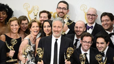 Jon Stewart (C), winner of multiple awards for The Daily Show, poses with cast and crew members. EPA