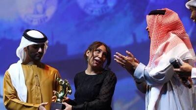 Haifa Al Mansour, the director of Wadjda, receives the Muhr Arab Feature Best Film at the Dubai International Film Festival in Dubai. Satish Kumar / The National