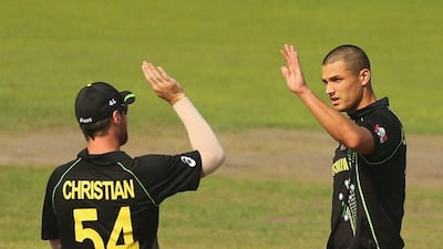 Nathan Coulter-Nile of Australia is congratulated by his teammates after dismissing Anamul Haque of Bangladesh at the World Twenty20 on Tuesday. Scott Barbour / Getty Images / April 1, 2014