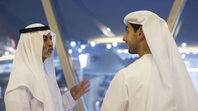 Sheikh Nahyan bin Mubarak, Minister of Culture, Youth and Community Development, left, speaks with Sheikh Khaled bin Zayed, Deputy Chairman of Etihad Airways, right, during the final day of the 2014 Formula 1 Etihad Airways Abu Dhabi Grand Prix at Yas Marina Circuit. Ryan Carter / Crown Prince Court — Abu Dhabi