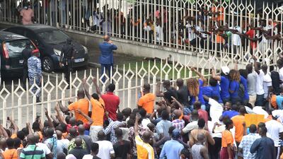 Didier Drogba (C) greets supporters. AFP