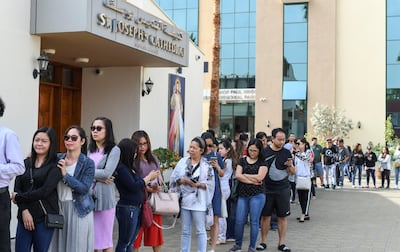 Long queues build for people collecting t-shirts for the Pope's visit to St Joseph's Cathedral on Tuesday. Khushnum Bhandari for The National