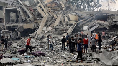 Palestinians inspect the damage of a destroyed building following Israeli air strikes on Gaza city. AP