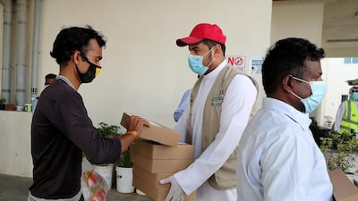 Volunteers distribute food packages in Dubai in May 2020, as the social and economic impact of the pandemic is felt