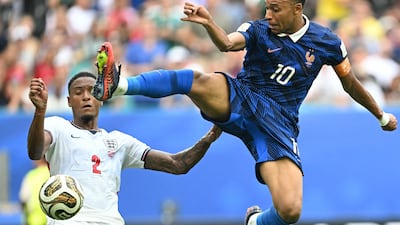 French striker Kylian Mbappe challenges English defender Ezri Konsa at the Miami Stadium. AFP