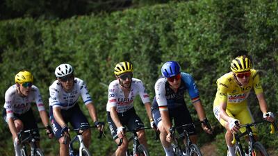 UAE Team Emirates' Tadej Pogacar, wearing the overall leader's yellow jersey, rides ahead of Israel-Premier Tech's Pascal Ackermann and UAE teammate Adam Yates. AFP