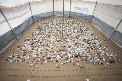 'Another Day Lost', an installation of recycled books and medical boxes housed inside a UNHCR tent, resembles a miniature model of a refugee camp. Courtesy Shubbak