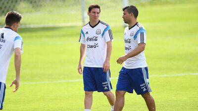 Lionel Messi and Sergio Aguero talk on the pitch during an Argentina training session on Wednesday ahead of their Saturday 2014 World Cup Group F match against Iran. Ronald Martinez / Getty Images / June 18, 2014