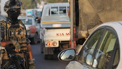 An Iraqi policeman mans a checkpoint in the capital Baghdad's predominantly Shiite Sadr City. Iraq's parliament held its first session today after a week of anti-government protests that left dozens dead and sparked a political crisis the country's president said required a "national dialogue". AFP