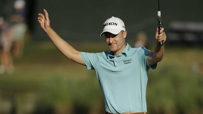 Russell Knox raises his arms after finishing the 17th hole. Chris O'Meara / AP Photo