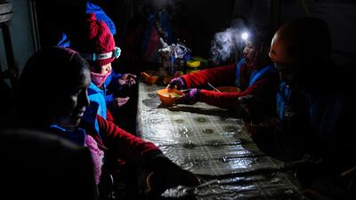 Aymara indigenous women enjoy hot soup before their summit bid.