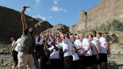 Volunteers, officials and staff members of Wadi Al Wurayah take a selfie with the Special Olympics torch “Flame of Hope” in Wadi Al Wurayah Waterfalls in Fujairah. Pawan Singh/The National