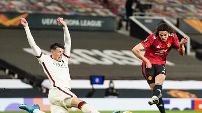 Manchester United's Edinson Cavani, kicks the ball during the Europa League semi final, first leg soccer match between Manchester United and Roma at Old Trafford in Manchester, England. AP