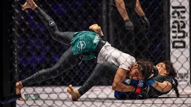 ZamZam Al Hammadi of the UAE tussles with Abeer Mansour of Egypt in a Professional Fighters League (Mena) bout. Antonie Robertson / The National