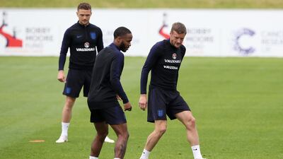 England's Raheem Sterling visibly showing an assault rifle tattoo on his leg during a training session at St George's Park, Burton. Nick Potts / PA