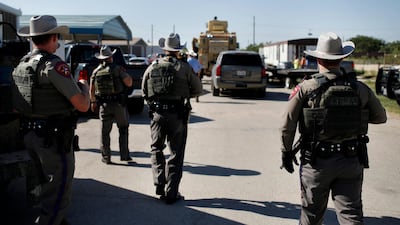 Texas State Troopers advance upon the scene at the bar Big Daddy Zane's near Odessa, Texas, where the Ector County Sheriff's Office made the arrest of eight individuals including the bar owner. AP