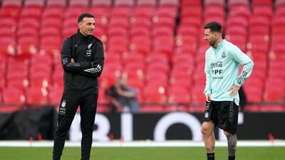 Argentina's Lionel Messi speaks to manager Lionel Scaloni. PA